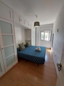 a small bedroom with a bed in a room at Sirena Center apartment in Seville