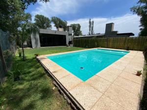 a swimming pool in the backyard of a house at Casa Los Nogales in Roldán