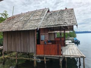 a house on a pier on the water at Tapor Pandera Homestay in Besir
