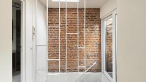 a glass shower in front of a brick wall at Loft Mons Centre 5 in Mons +17 photos