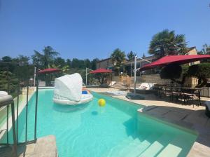 a pool with a boat and a yellow ball in it at Chambre d hôte grise avec petit déjeuner Sauna et Piscine inclus Jacuzzi en option in Sarlat-la-Canéda