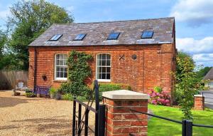 a brick house with a roof with windows at The Chapel, Dummer in Dummer