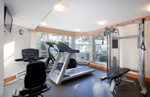 a room with a gym with a treadmill and two chairs at Woodrun Lodge 216 | Renovated Ski-In Ski-Out Condo w/ Free Parking, Pool, Hot Tub, & Gym in Whistler