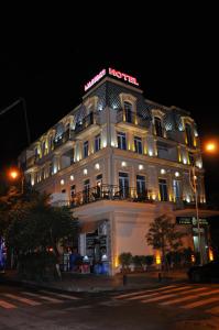 a hotel building with a sign on it at night at Black Sea Star Batumi in Batumi