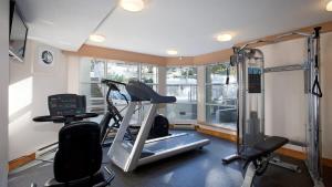 a room with a gym with a treadmill and a window at Woodrun Lodge 416 | Family Ski-In Ski-Out Condo, Hot Tub, Heated Pool, Parking & Laundry in Whistler