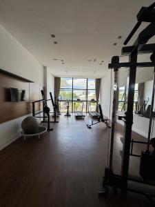 a gym with several tread machines in a room at Flat de alto padrão no centro da cidade in Campina Grande