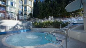 a hot tub on the side of a building at Woodrun Lodge 414 | Cozy Ski-In Ski-Out Condo w/ Shared Hot Tub, Pool, Fireplace, & Parking in Whistler