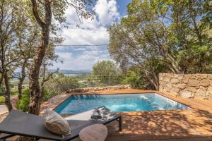 a swimming pool in the middle of a yard at Chalet U Picculu Di Arasu in Sainte-Lucie de Porto-Vecchio +14 photos