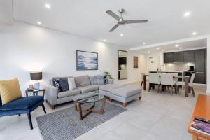 a living room with a couch and a table at Lagoon Sanctuary - Resort Living by Four Mile Beach in Craiglie