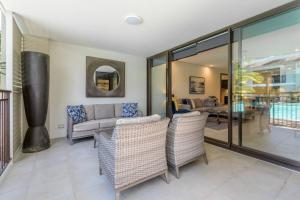 a living room with a couch and chairs at Lagoon Sanctuary - Resort Living by Four Mile Beach in Craiglie