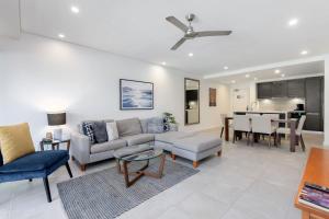a living room with a couch and a table at Infinity's Edge - Poolside Retreat at Temple Resort in Craiglie