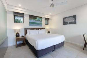 a bedroom with a large white bed in a room at Infinity's Edge - Poolside Retreat at Temple Resort in Craiglie +18 photos