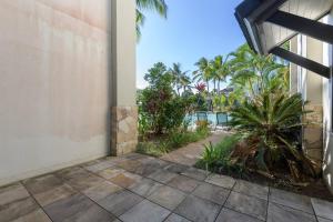 a view from the outside of a building with palm trees at Infinity's Edge - Poolside Retreat at Temple Resort in Craiglie