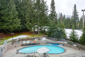 a swimming pool on top of a building at Woodrun Lodge 306 | Budget-friendly Ski-in-Ski-out Condo w/ Heated Pool, Hot Tub, Fireplace in Whistler