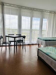 a room with a table and chairs and windows at Twój Hostel Bytom in Bytom +35 photos