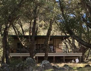 a house in the middle of some trees at Harrison Serenity Ranch - Large Group Accommodation in Palomar Mountain