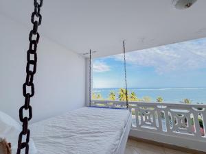 a swinging bed in a room with a view of the ocean at Wincome Beachfront Apartments in Mombasa +27 photos