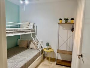 a small room with a bunk bed and a table at Apartamentos Duque Cartagena in Cartagena