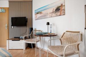 TV a/nebo společenská místnost v ubytování Ferienwohnung Lütte Veer