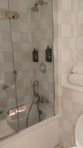 a bathroom with a shower with a glass door at London Thames Lodge by Dancenter in Staines
