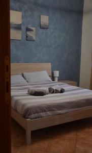 a bed in a bedroom with two beds with blankets at L'appartamento blu di Nicole in Turin