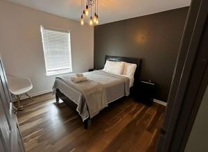 a bedroom with a bed and a chair and a window at 3BR Lakefront in Nashville with BBQ & Hot Tub in Old Hickory