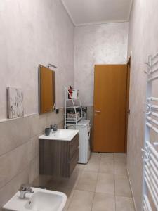 a bathroom with a sink and a washing machine at L'appartamento blu di Nicole in Turin