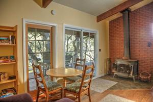 a dining room with a table and a fireplace at Harrison Serenity Ranch - Large Group Accommodation in Palomar Mountain
