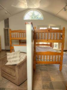 a bedroom with two bunk beds and a couch at Harrison Serenity Ranch - Large Group Accommodation in Palomar Mountain +59 photos