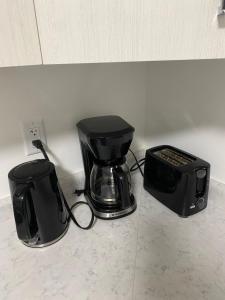 a blender and a toaster sitting on a counter at Cozy 2-Bedroom Suite in Aspen Ridge in Saskatoon