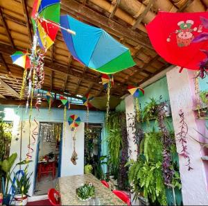 a room with umbrellas hanging from the ceiling at HOSTEL RAIZ da BAHIA in Salvador