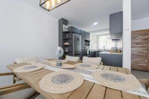 a kitchen with a wooden table with plates on it at Elegant apartment in Trou-aux-Biches, 65 m², sea view in Trou aux Biches