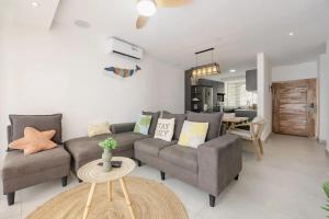 a living room with a couch and a table at Comfortable House in Trou-aux-Biches with Terrace in Trou aux Biches