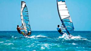 two people are windsurfing in the ocean at Villa Leonidas in Mastihari
