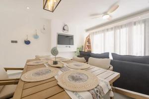 a living room with a table and a couch at Comfortable House in Trou-aux-Biches with Terrace in Trou aux Biches