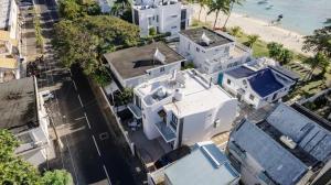an aerial view of a white house next to the beach at Comfortable House in Trou-aux-Biches with Terrace in Trou aux Biches