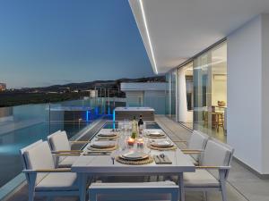 a dining table and chairs on the balcony of a house at Villa Deluxe 1&2 - Casangular by Upper in Adeje
