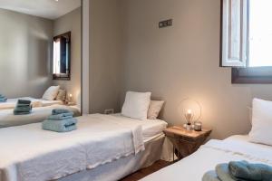 a room with three beds with towels on them at Luxury Villa With Pool And Seaview in Nuestra Señora de Jesus +36 photos