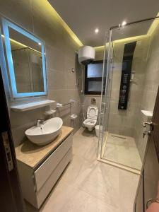 a bathroom with a sink and a shower and a toilet at Beverly hills westtown in Sheikh Zayed
