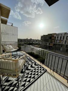 a balcony with a chair and a table on a balcony at Beverly hills westtown in Sheikh Zayed +4 photos