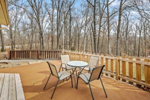 a patio with a table and chairs on a deck at Bike -Lovers & Pets Welcome Modern Home by Bamboozled Trail in Bella Vista
