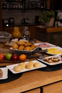 a table with several plates of food on it at Hotel Cordillera in El Bolsón