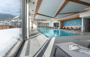 a house with a swimming pool with a view at MGM Hôtels & Résidences - Résidence Chalets de Joy in Le Grand-Bornand