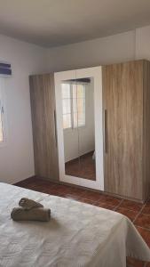 a bedroom with a large mirror and a bed at Lucia Home in Moya