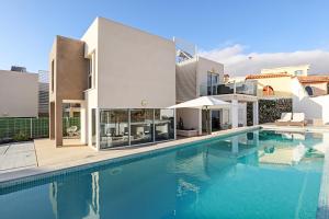 a large swimming pool in front of a house at Nirvana - Luxury Villa with heated pool in Playa Paraiso