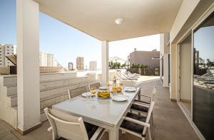 a dining room with a table and chairs on a balcony at Nirvana - Luxury Villa with heated pool in Playa Paraiso