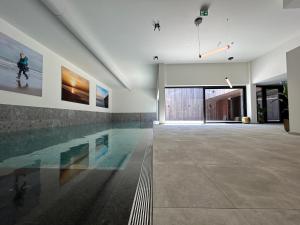 a swimming pool in the middle of a house at Faro Greenpark, Cadzand-Bad Penthouse in Cadzand