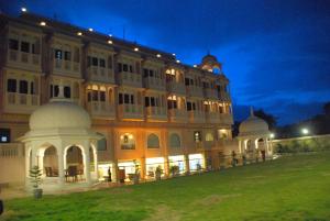 Un gran edificio con césped delante. en The Royal Retreat, en Ranchi
