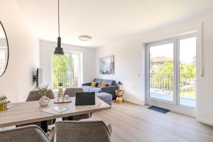 a living room with a table and chairs and a couch at Apartment- Suite "ZIEGELHOF" in Niederdorla
