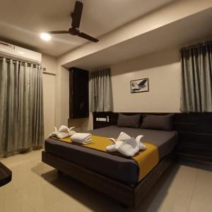 a bedroom with a bed and a ceiling fan at Hotel ESSENCE in Vellore +122 photos